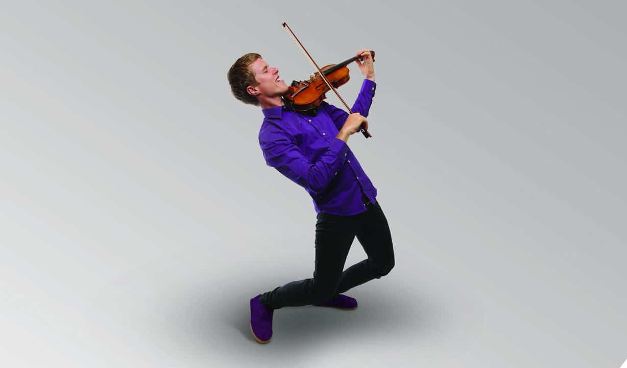 Man in purple shirt and shoes playing the violin